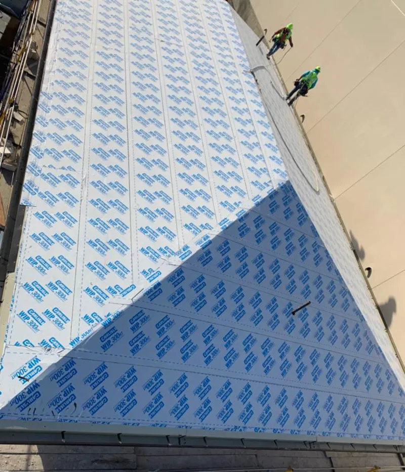 Professional roofers installing underlayment on a metal roof in Good Hope